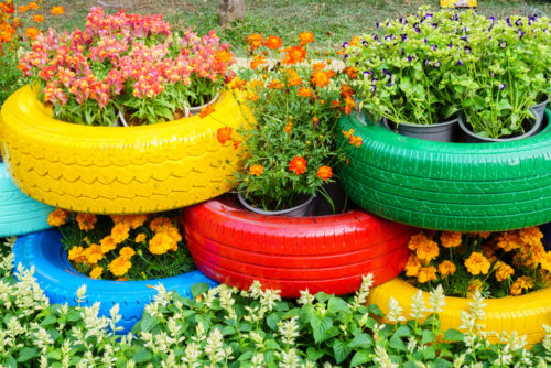 Colorful flowers growing in tyre pot containers. www.gromor.ie